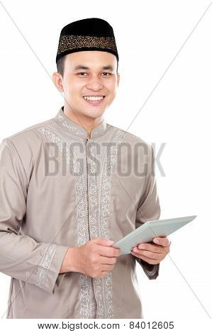 Young Muslim Man Holding A Tablet