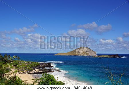 Makapuu Beach With People In The Water, And Rabbit And Rock Island In The Distance