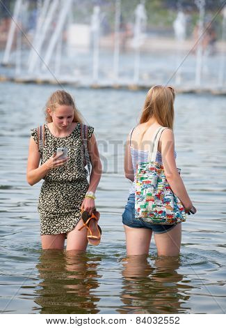 Two Girls Standing In Water