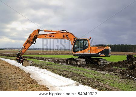 Hyundai Robex 210LC-9 Crawler Excavator On A Field At Spring