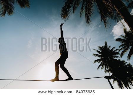 Teenage Girl  Balancing On Slackline With Sky View