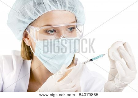 Female Scientist With A Syringe And An Egg