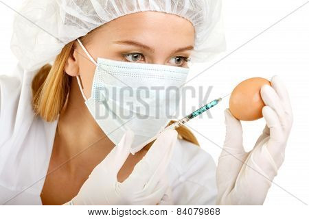 Female Scientist With A Syringe And An Egg