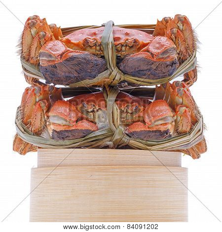 Hairy crabs on the Bamboo steamer Isolated in white background.