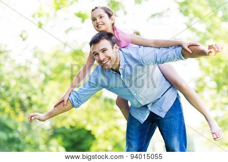Father and daughter playing outdoors 