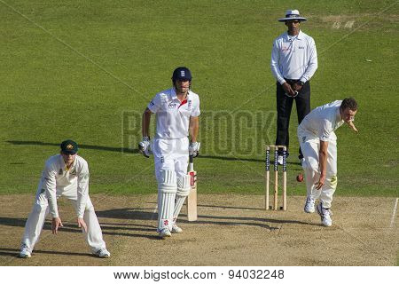 NOTTINGHAM, ENGLAND - July 11, 2013: Steven Smith Alastair Cook Aleem Dar look on as Peter Siddle bowls the ball during day two of the first Investec Ashes Test match at Trent Bridge Cricket Ground