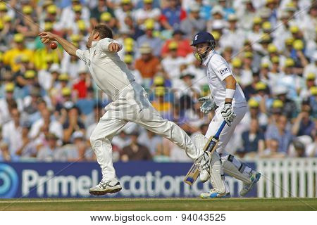 LONDON, ENGLAND - August 23 2013: Ryan Harris fails to stop the ball as Joe Root looks on during day three of the 5th Investec Ashes cricket match between England and Australia