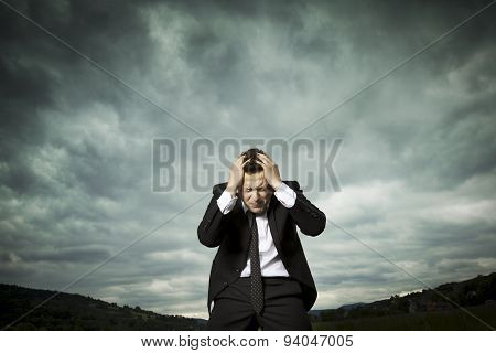 Tired young businessman, headache