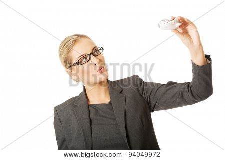 Beautiful businesswoman with plane toy in hand