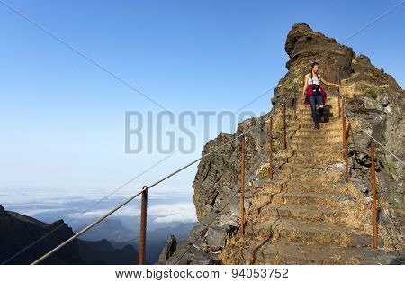 Young girl on the winding mountain trekking path at Pico do Areeiro, Madeira, Portugal