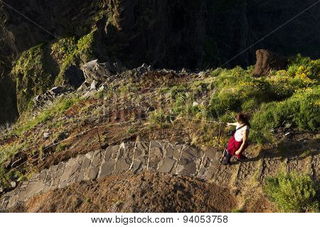 Young girl on the winding mountain trekking path at Pico do Areeiro, Madeira, Portugal