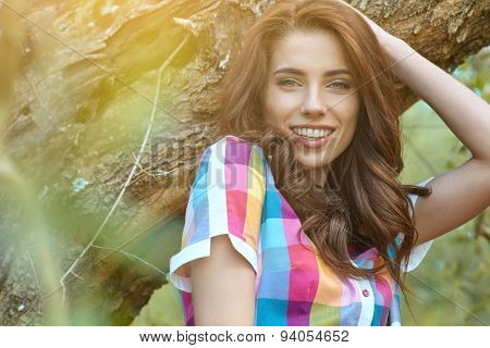Beautiful woman under an olive tree