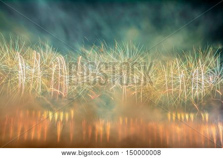 Beautiful firework display in red orange green and white with a lot of smoke around