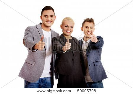 Three business people showing thumbs up