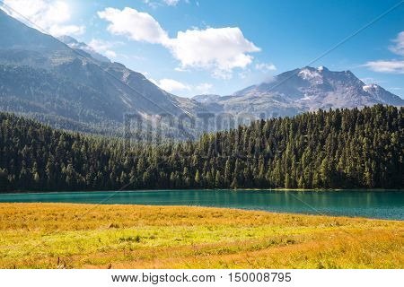 Great view of the azure pond Champfer in alpine valley. Popular tourist attraction. Picturesque and gorgeous scene. Location Swiss alps, Silvaplana village, district of Maloja, Europe. Beauty world.