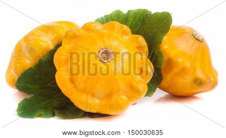 three yellow pattypan squash with leaf isolated on white background.