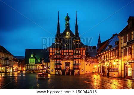 WERNIGERODE, HARZ/ GERMANY - JANUARY 10, 2015: Town Hall in the Market Square on a rainy winter evening.