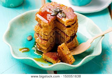 Pumpkin paleo pancakes on blue plate . selective focu