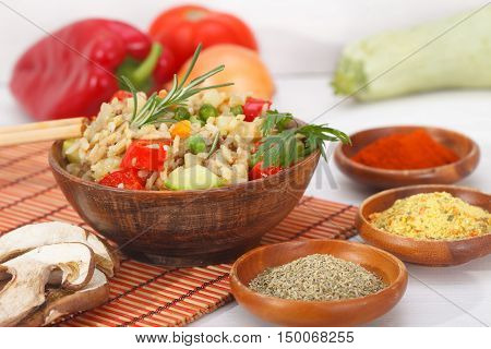 Homemade Chinese fried rice with vegetables and mushroom served in a bowl with chopsticks