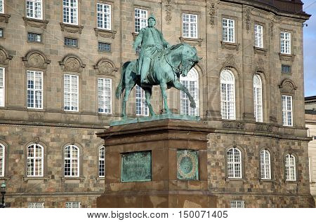 The equestrian statue of King Frederik VII in front of the Christiansborg Palace in Copenhagen Denmark
