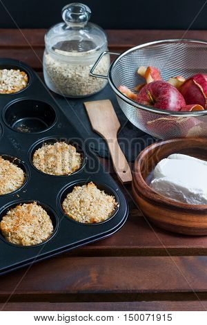 Muffins in the oven tray, oats, quark and apples