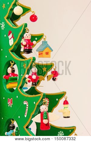 Cute Moe green wooden Christmas tree of red ribbon.