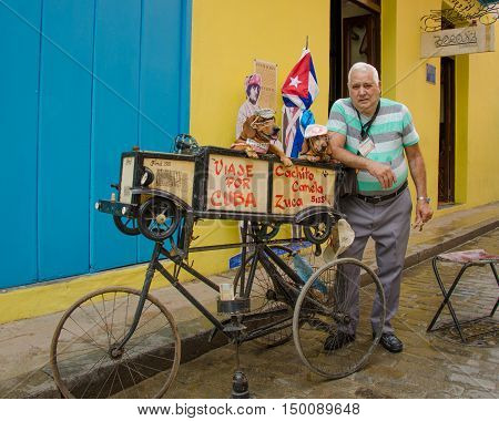 HAVANA - CUBA JUNE 9, 2016: Two dachshunds are dressed up by their owner to attract donations from passers-by of the Ambos Mundos Hotel to supplement his income.