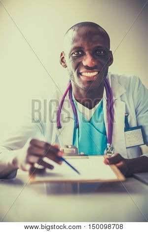 Male doctor sitting at his desk