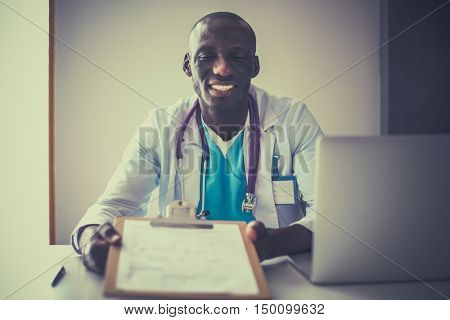 Male doctor sitting at his desk