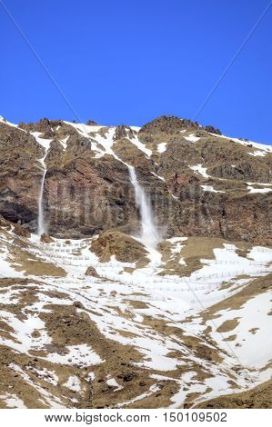 Slope of mountain Elbrus. Tails of little avalanche from the comb of mountain