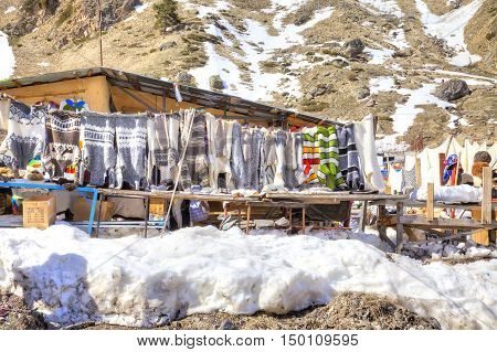 CAUCASUS RUSSIA - May 01.2015: Sale of warm things on the glade of Azau in the settlement of skiers at the foot of mountain Elbrus