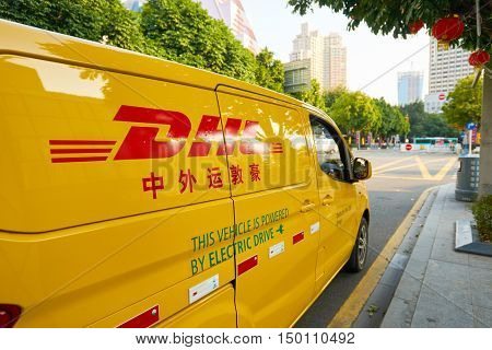 SHENZHEN, CHINA - FEBRUARY 05, 2016: a DHL car in the street. DHL Express is a division of the German logistics company Deutsche Post DHL providing international express mail services.
