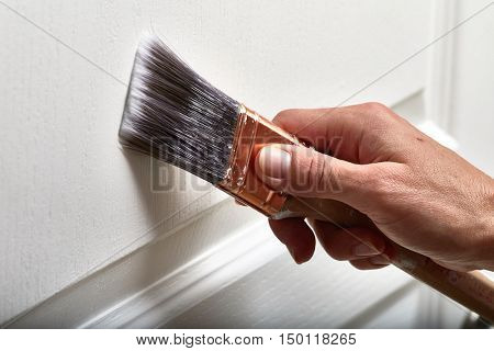 Hand with a paint brush.
