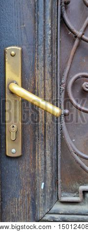 The iron doorhandle on the wooden doors