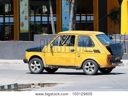 Varadero, Cuba - September 11, 2016:  Yellow Classic Car Dirves in Varadero City, Cuba