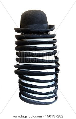 black bowler hats on a stack isolated against a white background vertical selected focus and narrow depth of field