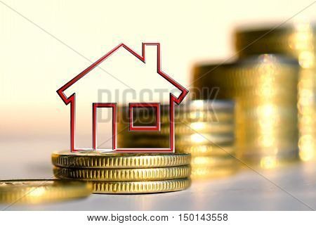 Red hause on a background of columns of coins . The concept of financial instability on the market .