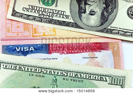 The American visa on page of the international passport and US dollars