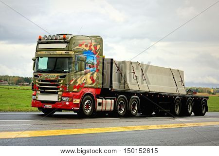 TAMMELA, FINLAND - SEPTEMBER 4, 2016: Colorful Arendal Scania R560 semi truck in concrete slab transport along highway.