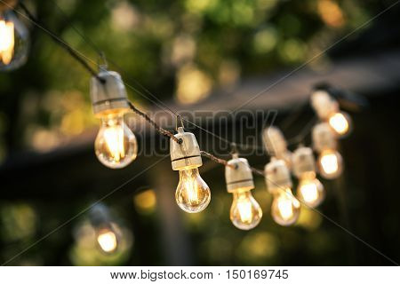 outdoor string lights hanging on a line in backyard