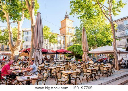 Salon-de-Provence, France - June 17, 2016: View on the central square with cafes, bars and old city gate or clock tower in Salon-de-Provence