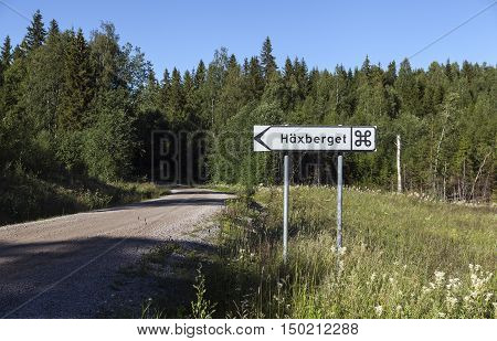 Road sign to the memorial, landmark of a witch trials, which took place in 1675 in Torsaker, Sweden. 71 people, 65 women and 6 men were beheaded and then burned.
