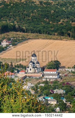Landscape view with Capriana Monastery and the village around. Winter Church visible at center was built in Neo-Byzantine style in 1903. Capriana Orthodox Christian Monastery is one of the oldest