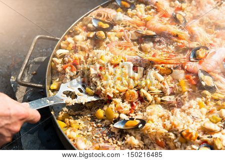 Preparing Paella Rice And Fish