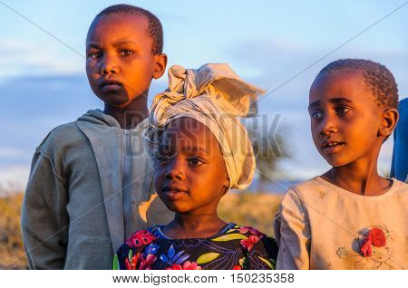 LAKE EYASI, TANZANIA - MAY 29, 2015: Kids from a Datoga tribe playing at sunset at Lake Eyasi Tanzania