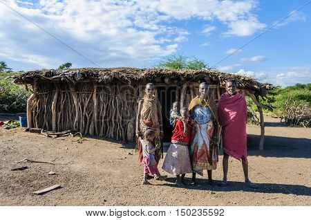 LAKE EYASI, TANZANIA - MAY 29, 2015: A Datoga family in front of their home at Lake Eyasi Tanzania