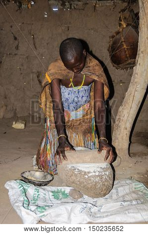 LAKE EYASI, TANZANIA - MAY 29, 2015: Datoga woman working at home at Lake Eyasi Tanzania