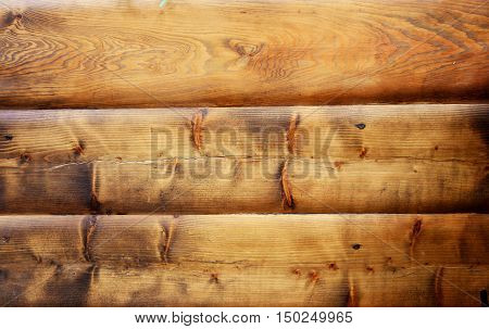 Brown cracky painted fence with wooden boards.