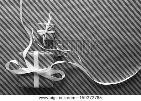 Two Gifts Or Presents With White Ribbon. Black And White Striped Wrapping Paper. Copy Space For Advertisement Or Your Free Text. Christmas Or Greeting Card.