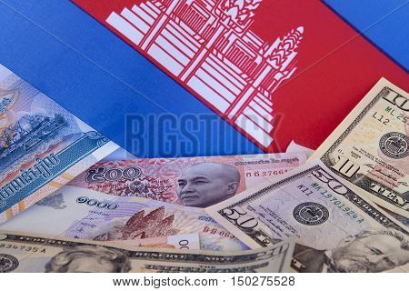 Cambodian currency: Cambodian riel, American dollars and flag.